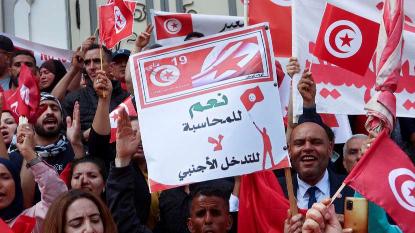 FILE PHOTO: Supporters of Tunisian President Kais Saied carry flags and signs during a demonstration in Tunis