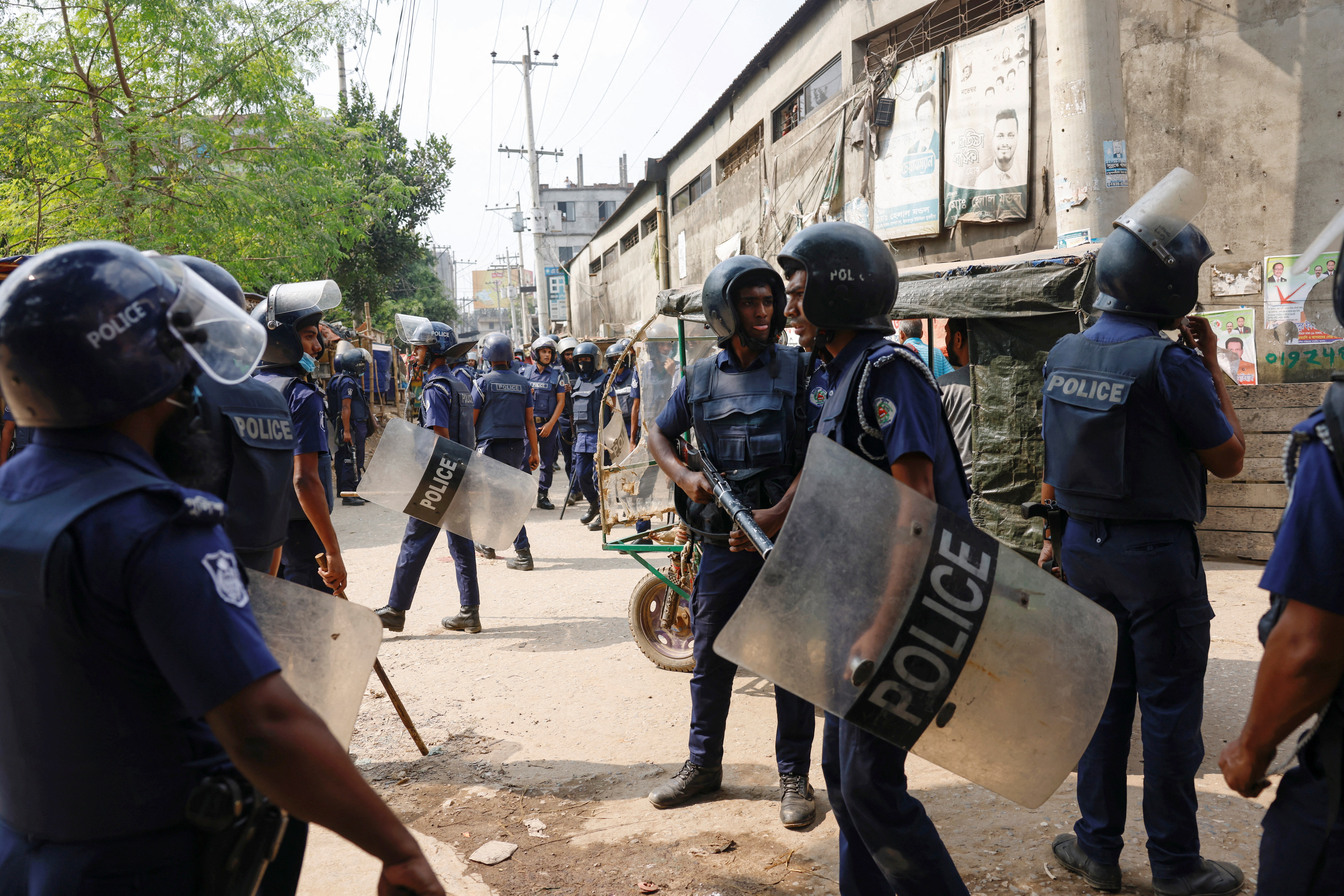 Security forces remain vigilant in front of the garment factories, following clashes between garment industry workers and police over pay, at the Ashulia area