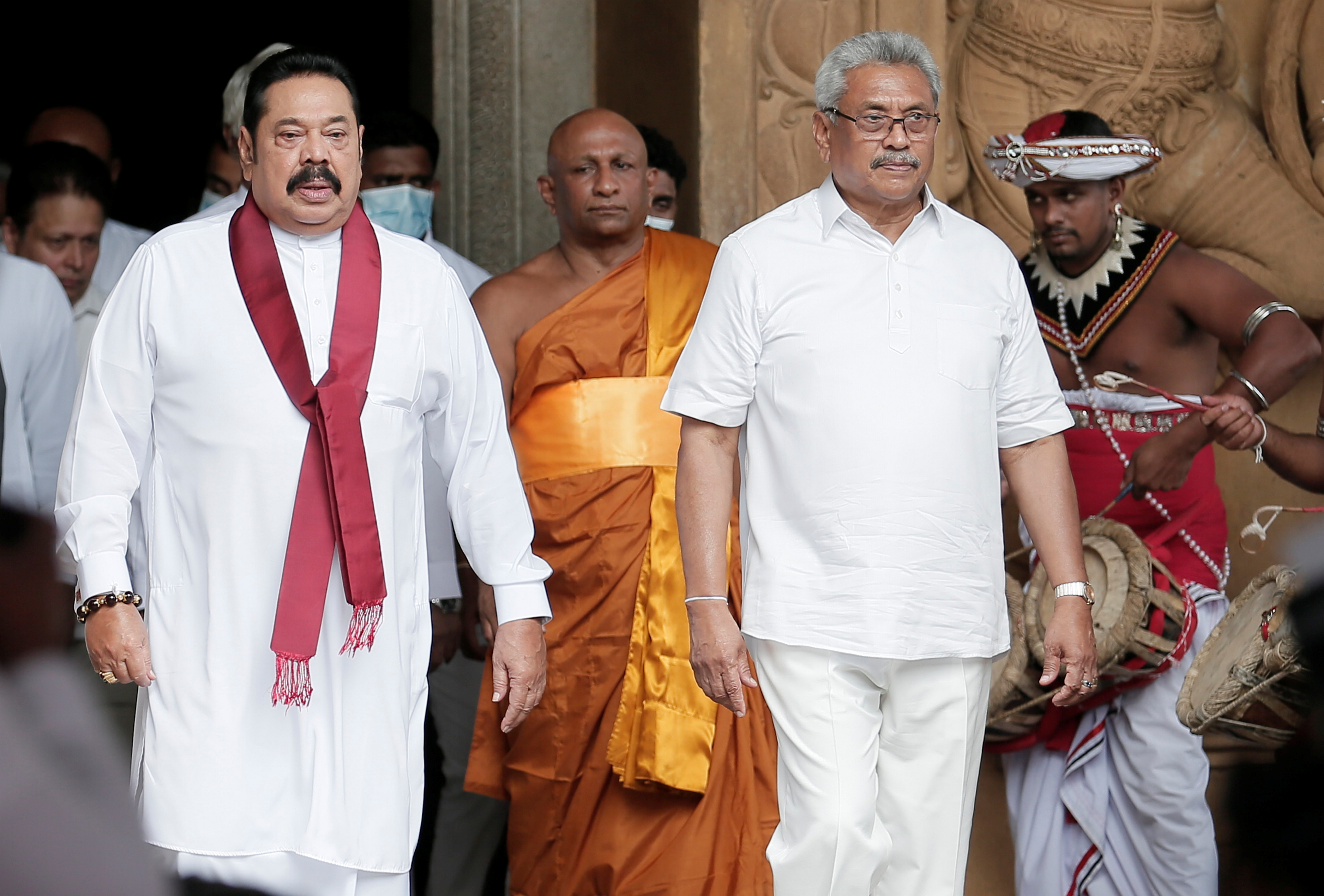 Sri Lanka's Prime Minister Mahinda Rajapaksa and his brother, and Sri Lanka's President Gotabaya Rajapaksa are seen during his during the swearing in ceremony as the new Prime Minister, at Kelaniya Buddhist temple in Colombo