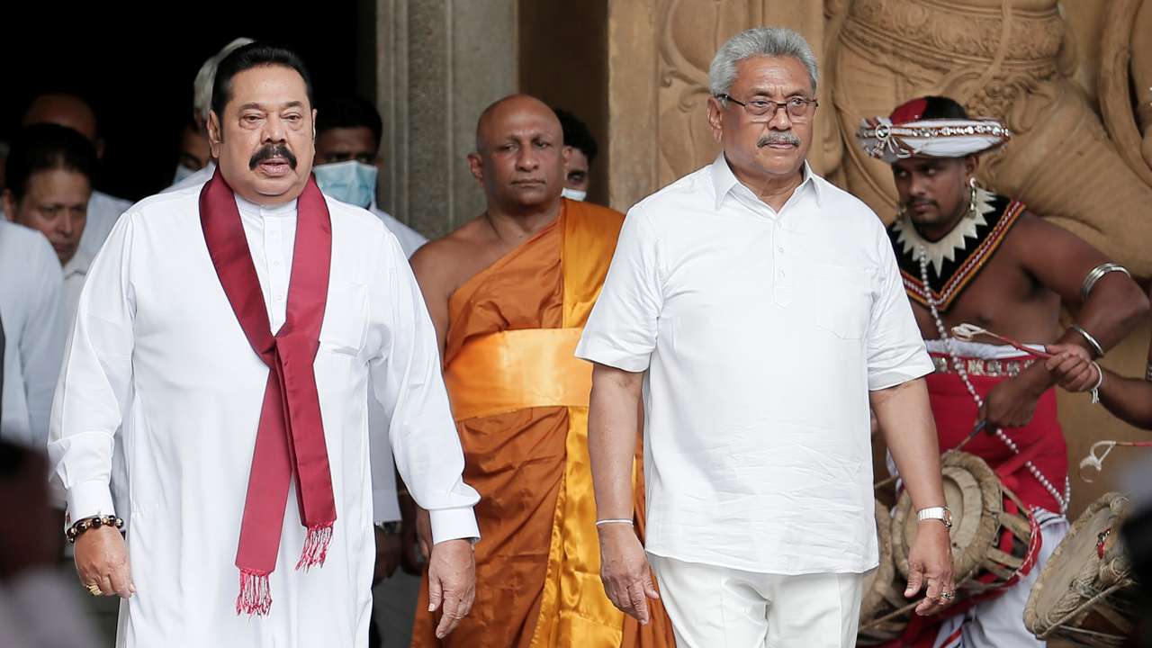 Sri Lanka's Prime Minister Mahinda Rajapaksa and his brother, and Sri Lanka's President Gotabaya Rajapaksa are seen during his during the swearing in ceremony as the new Prime Minister, at Kelaniya Buddhist temple in Colombo