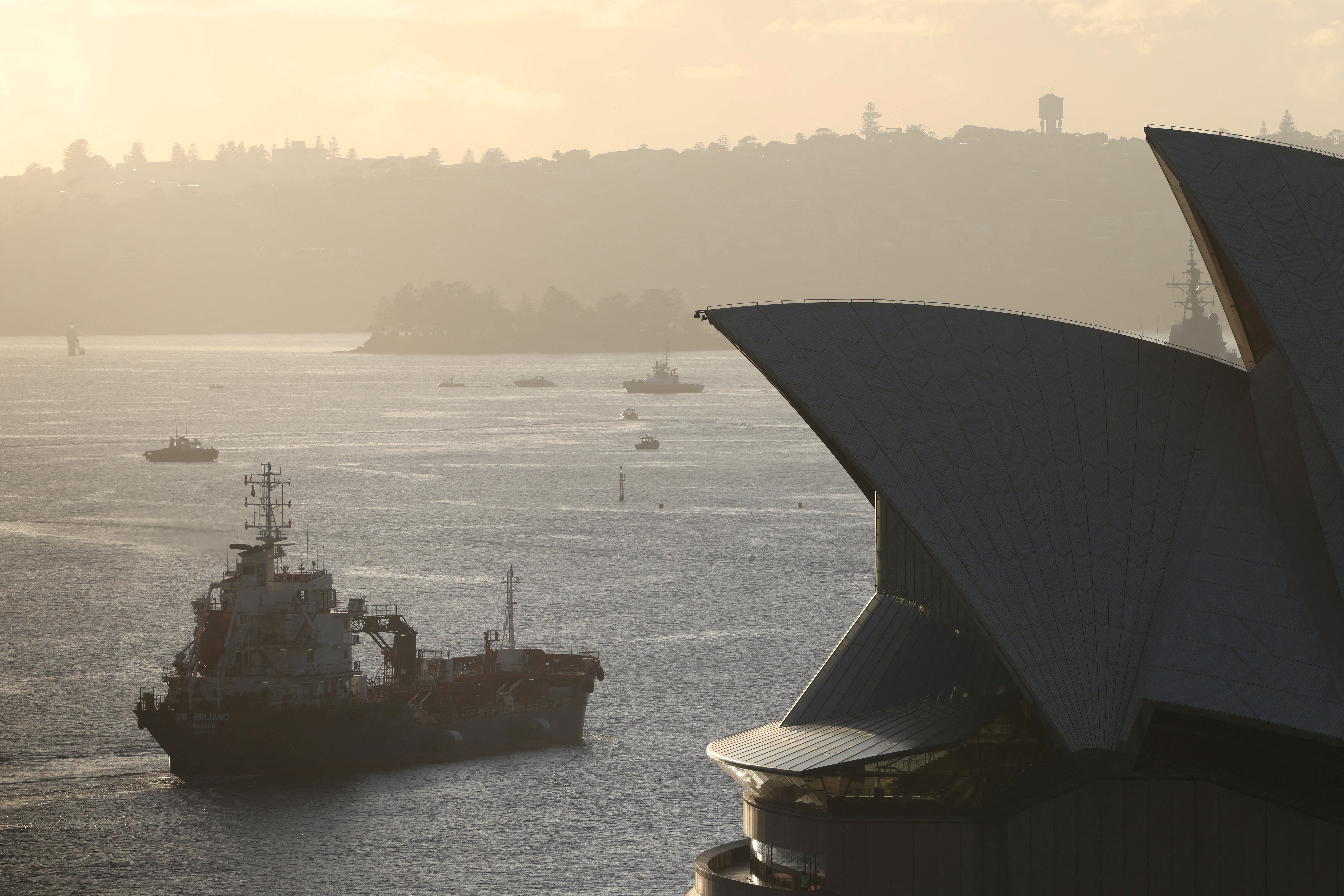 FILE PHOTO: An oil products tanker passes the Sydney Opera House at sunrise in Sydney