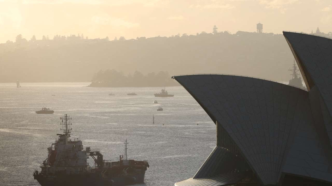 FILE PHOTO: An oil products tanker passes the Sydney Opera House at sunrise in Sydney