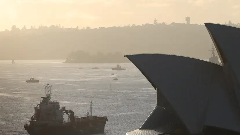 FILE PHOTO: An oil products tanker passes the Sydney Opera House at sunrise in Sydney