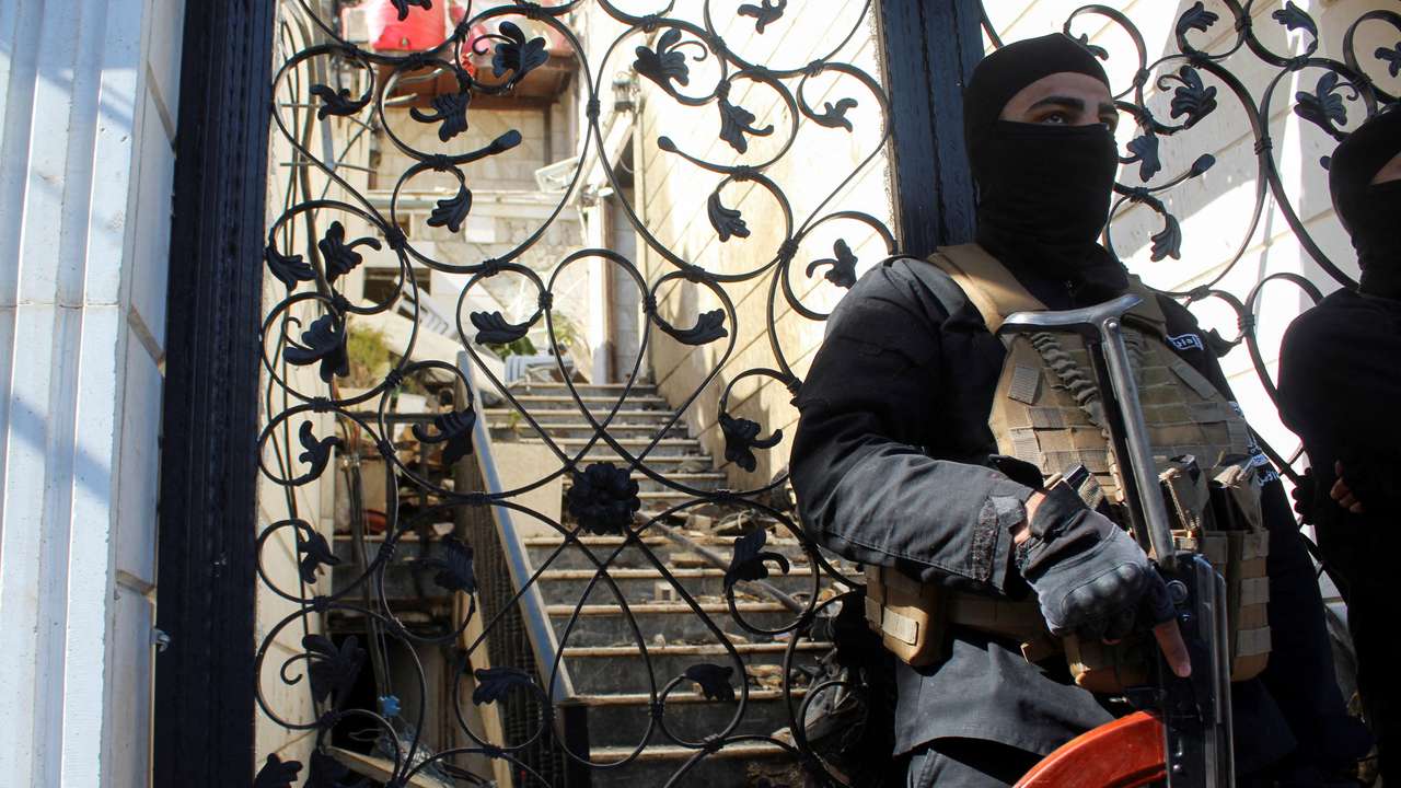 FILE PHOTO: A member of Syrian security forces stands guard at a damaged site, after Israel carried out an air strike on the Syrian capital Damascus on Thursday