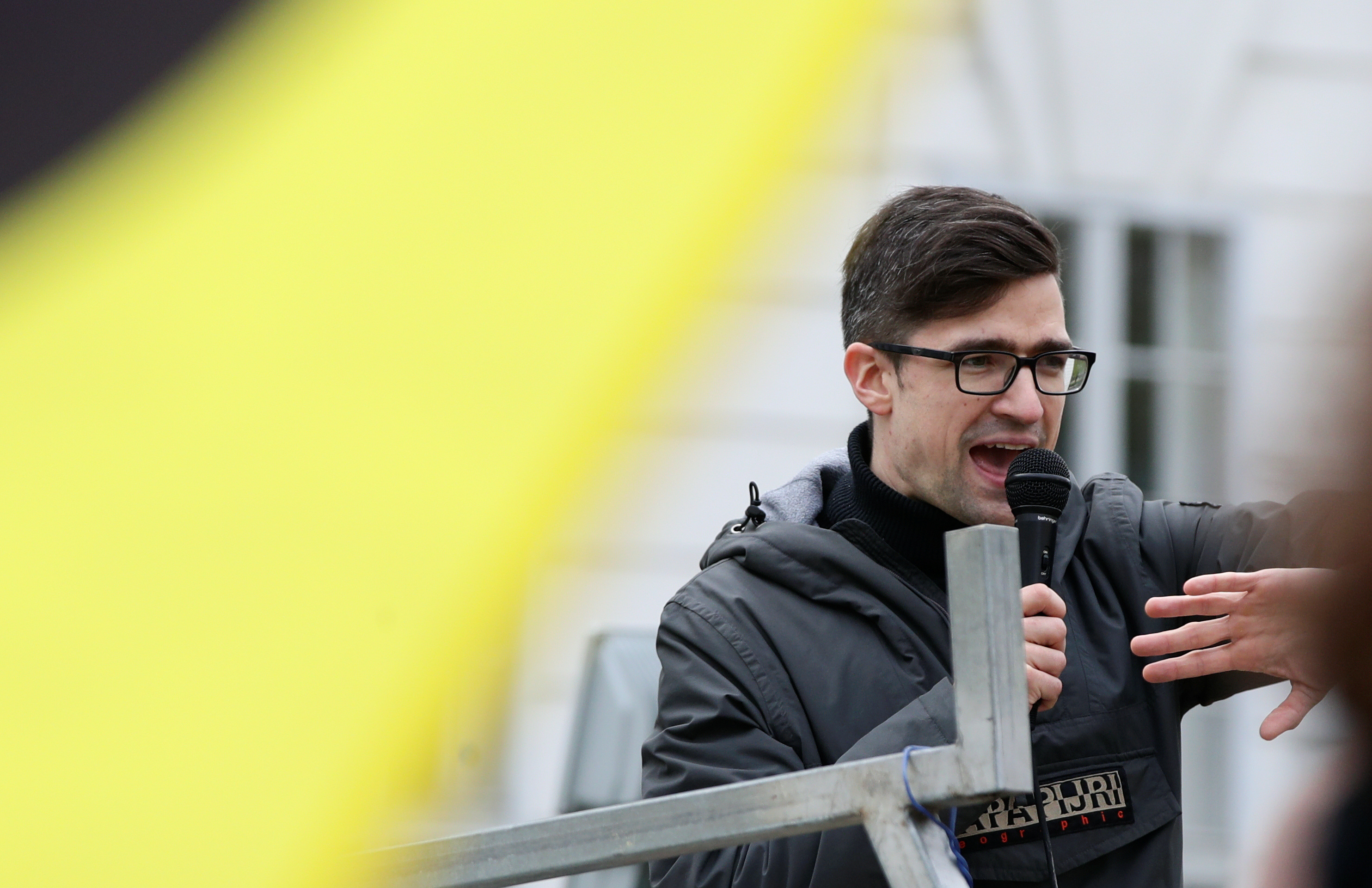 Leader of Austria's Identitarian Movement Martin Sellner speaks during a protest against a police raid at his house, outside the Justice Ministry in Vienna