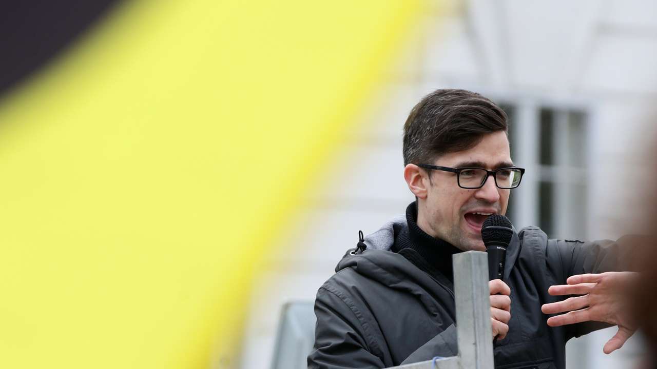 Leader of Austria's Identitarian Movement Martin Sellner speaks during a protest against a police raid at his house, outside the Justice Ministry in Vienna