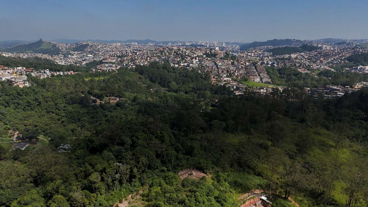 FILE PHOTO: A drone view shows the city and an area under permanent protection that was illegally deforested, in Maua