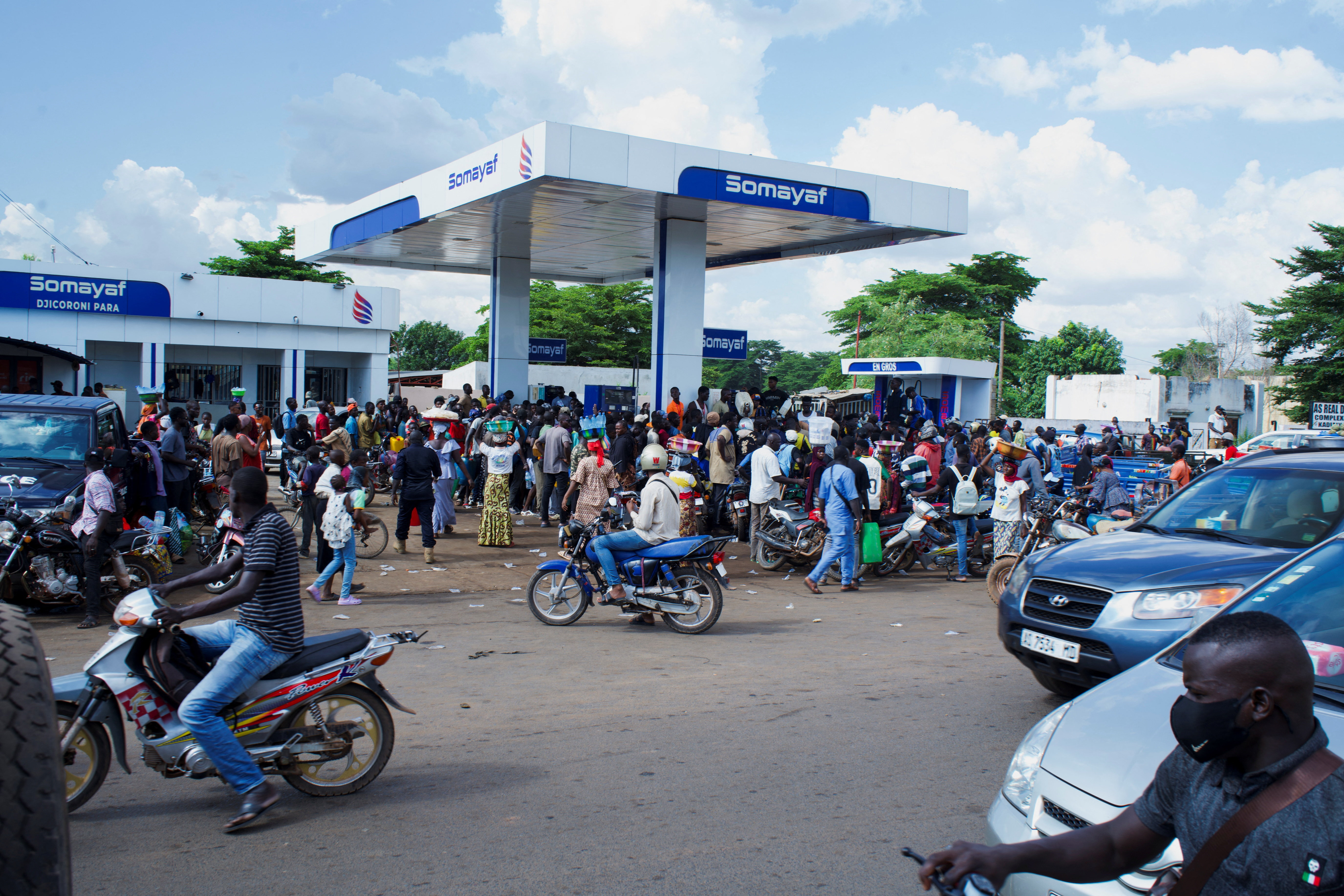 People gather at a petrol station due to shortage of petrol in Bamako