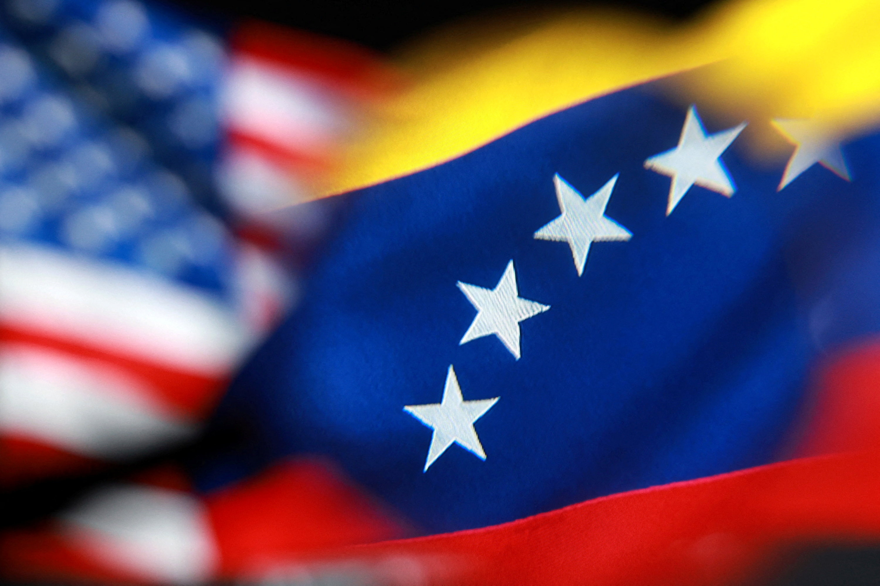 Illustration shows U.S. and Venezuelan flags