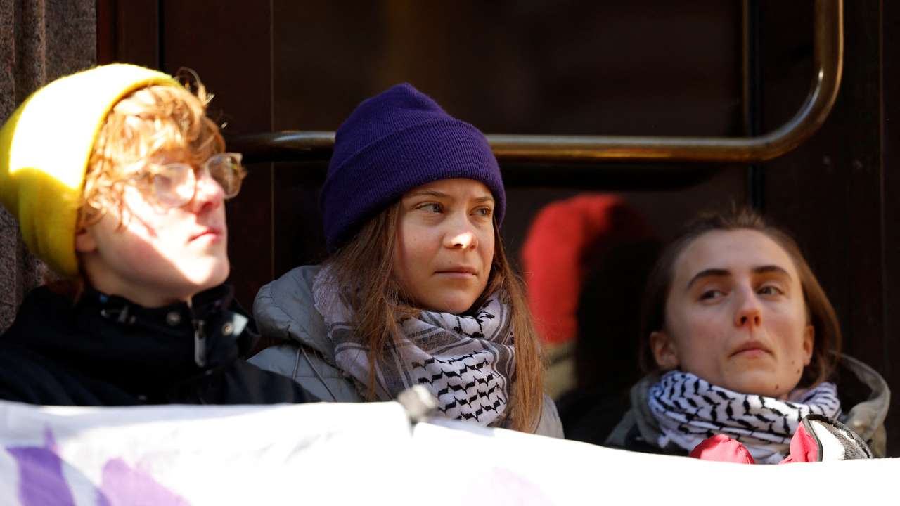 Climate activist Greta Thunberg blocks the entrance of the Swedish Parliament during a protest in Stockholm