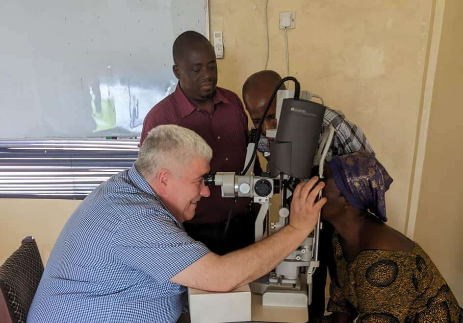 Prof Colin Willoughby treating patients in Sierra Leone