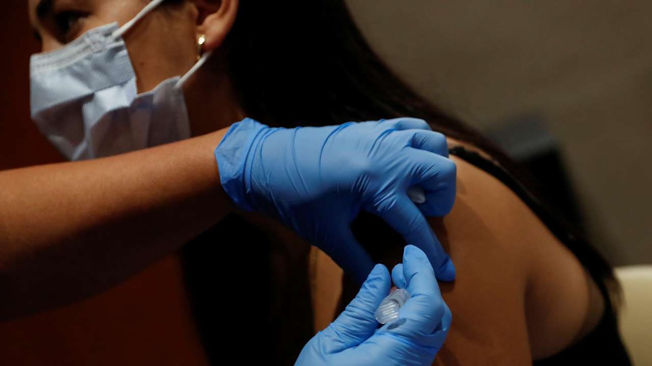 FILE PHOTO: A nurse applies a dose of COVID-19 vaccine in Sarasota