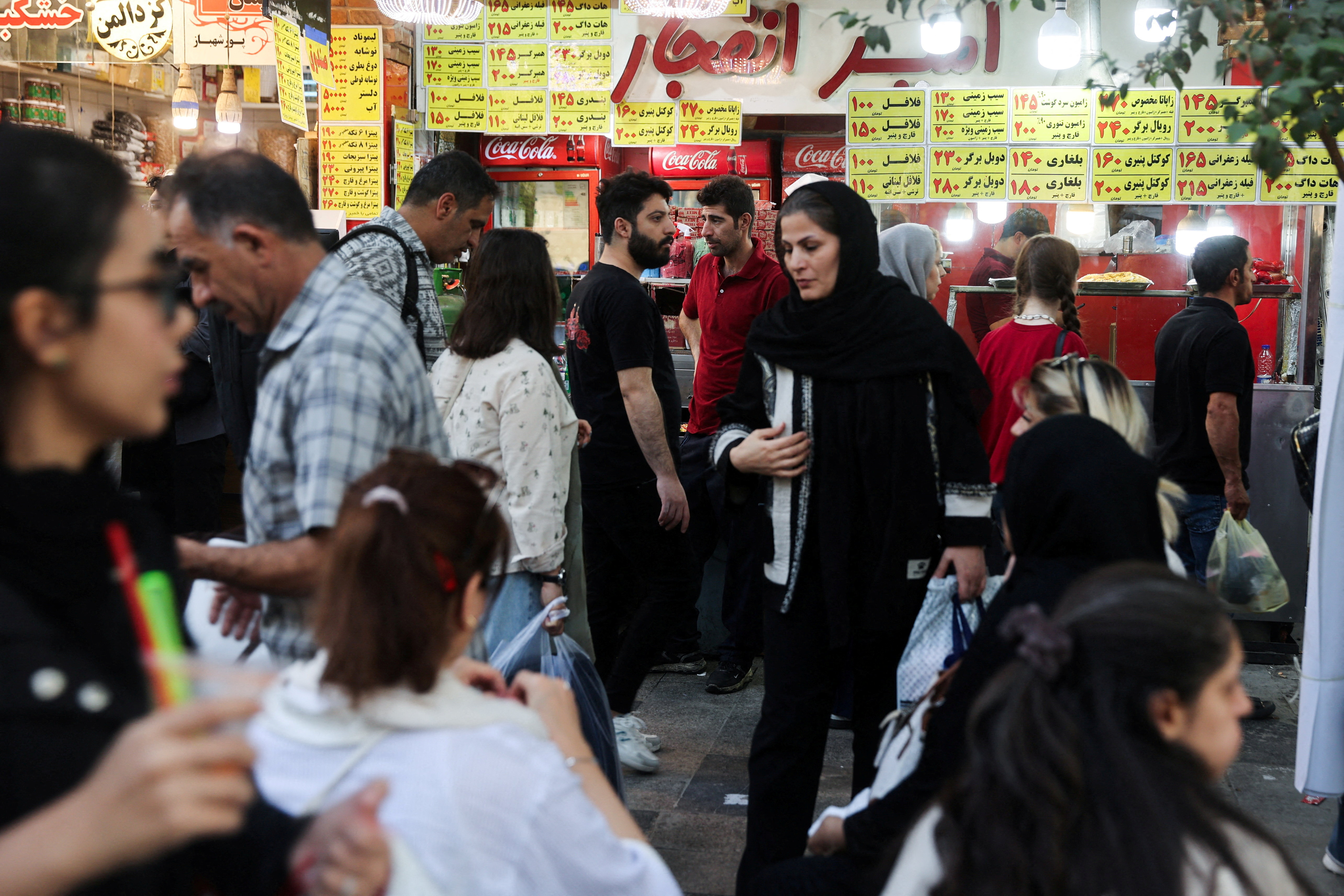 FILE PHOTO: Iranian people walk at the Tehran Bazaar