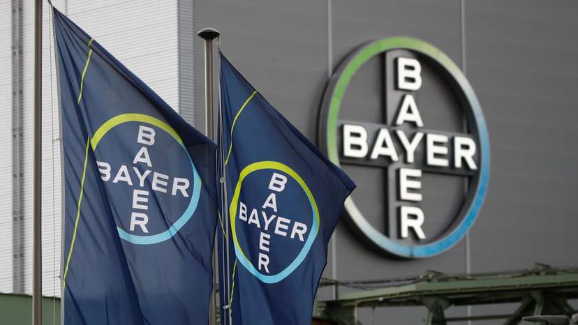 Logo and flags of Bayer AG are pictured outside a plant of the German pharmaceutical and chemical maker in Wuppertal