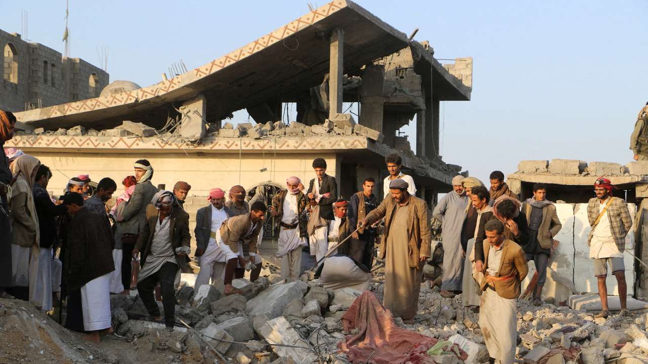People gather on the rubble of a house hit by a U.S. strike in Saada