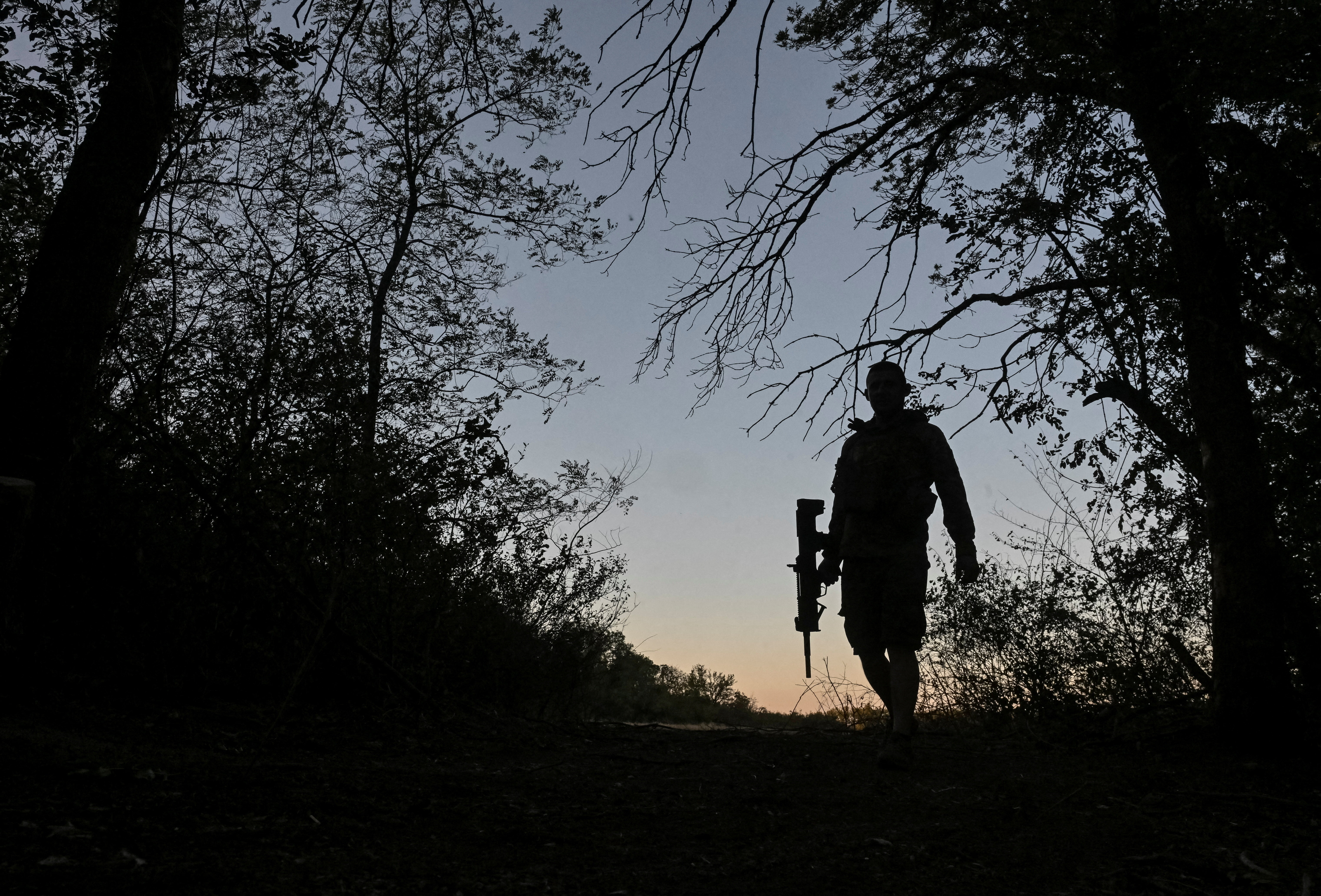 Ukrainian serviceman walks at a position near a front line in Donetsk region