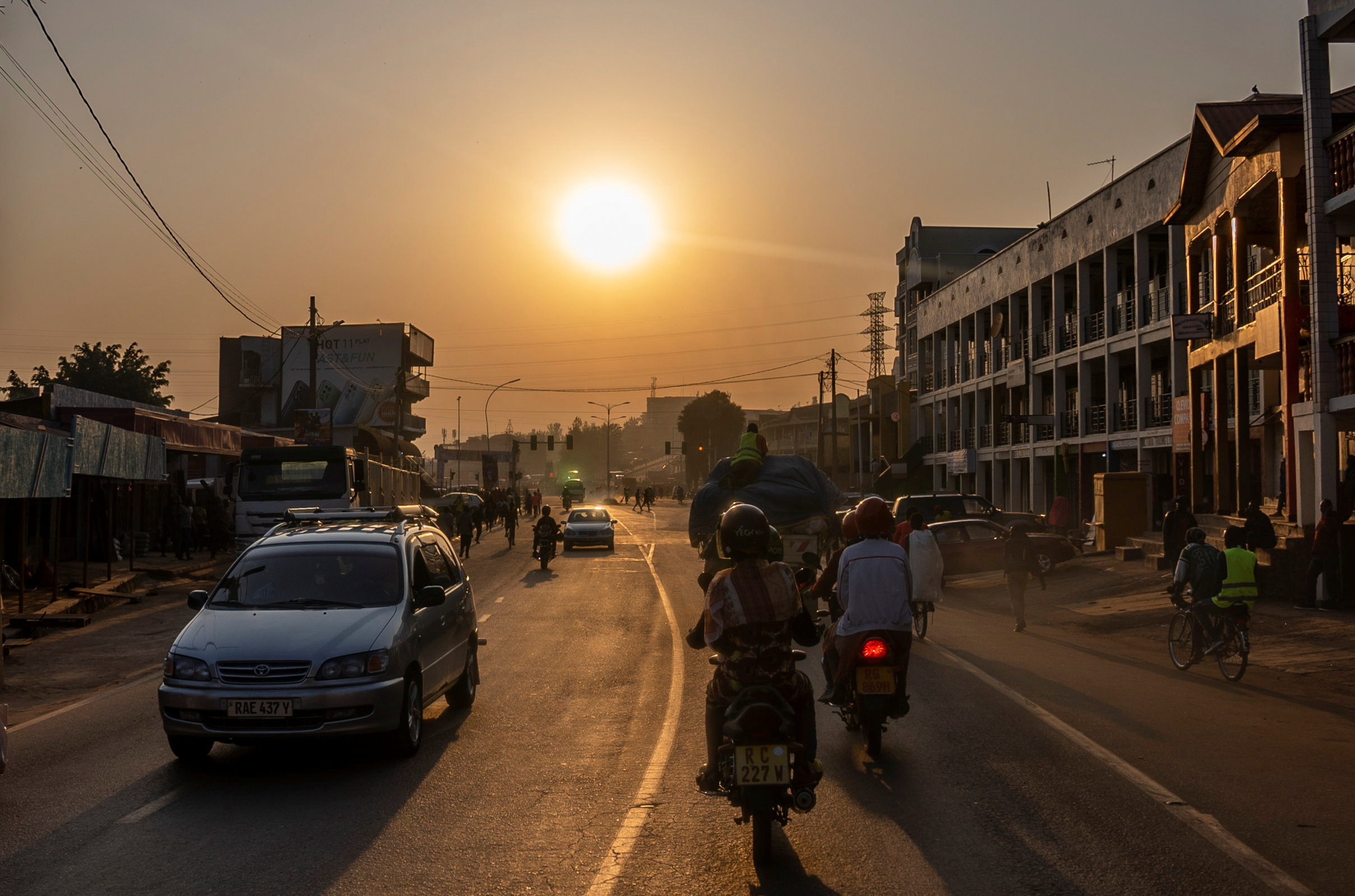 Residents commute along a street in downtown Kigali