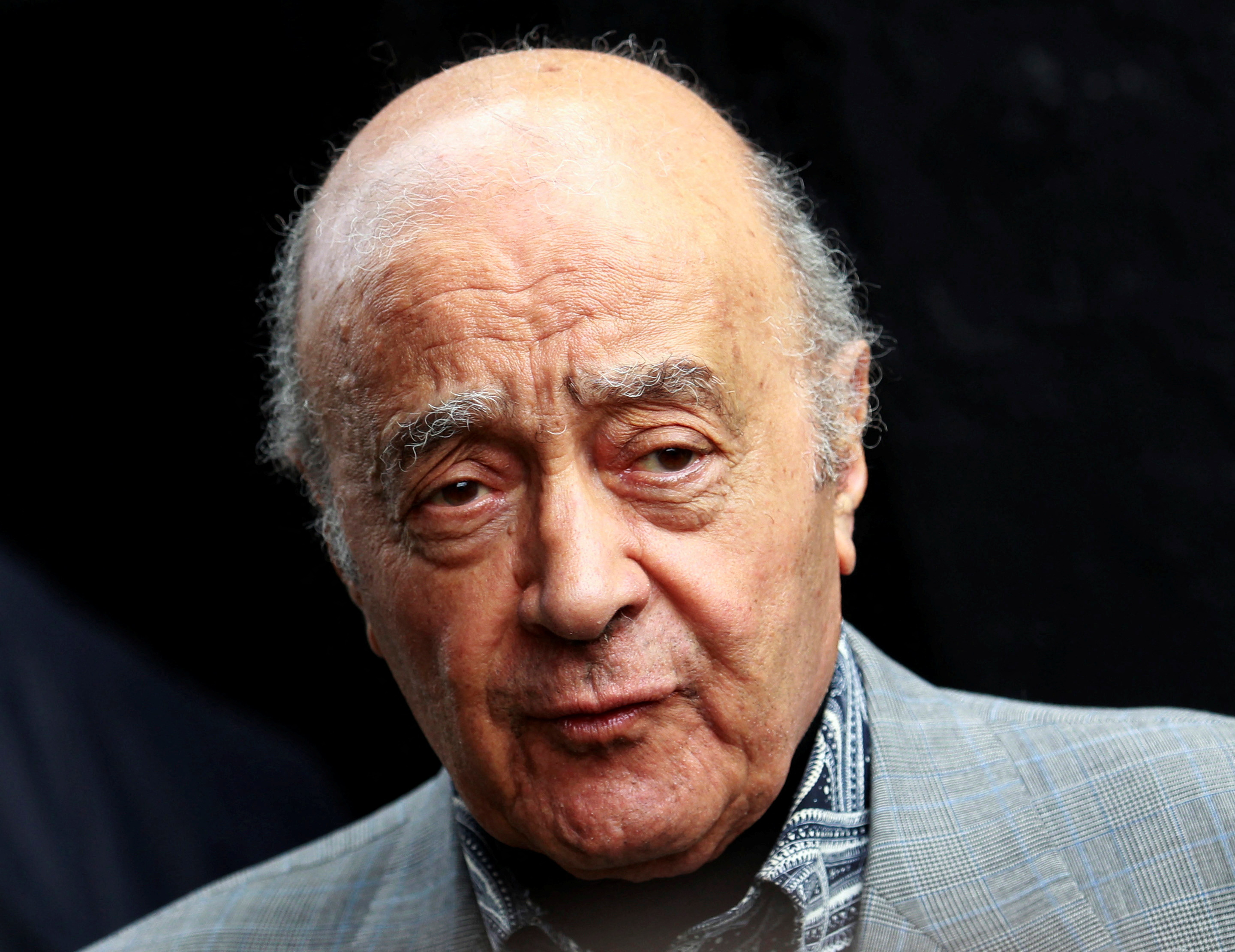 FILE PHOTO: Fulham's chairman Mohamed Al Fayed listens as Fulham's new manager Mark Hughes speaks during a news conference at Craven Cottage stadium in London