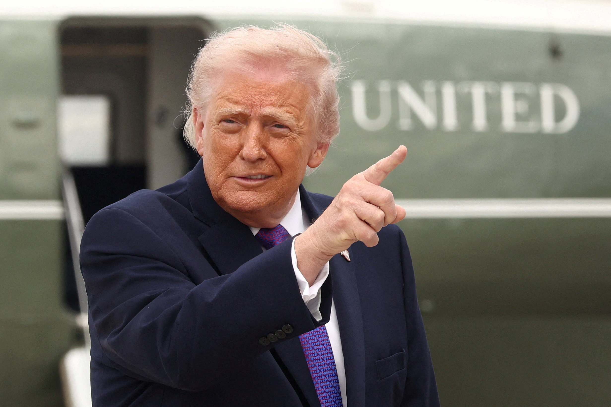 U.S. President Donald Trump gestures at Joint Base Andrews in Maryland