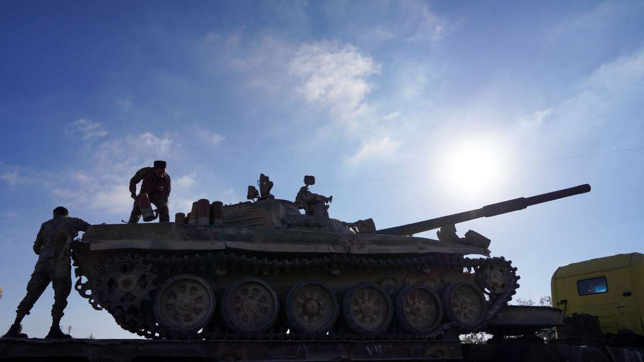 A member of the Syrian security forces stands on a military vehicle in Sweida