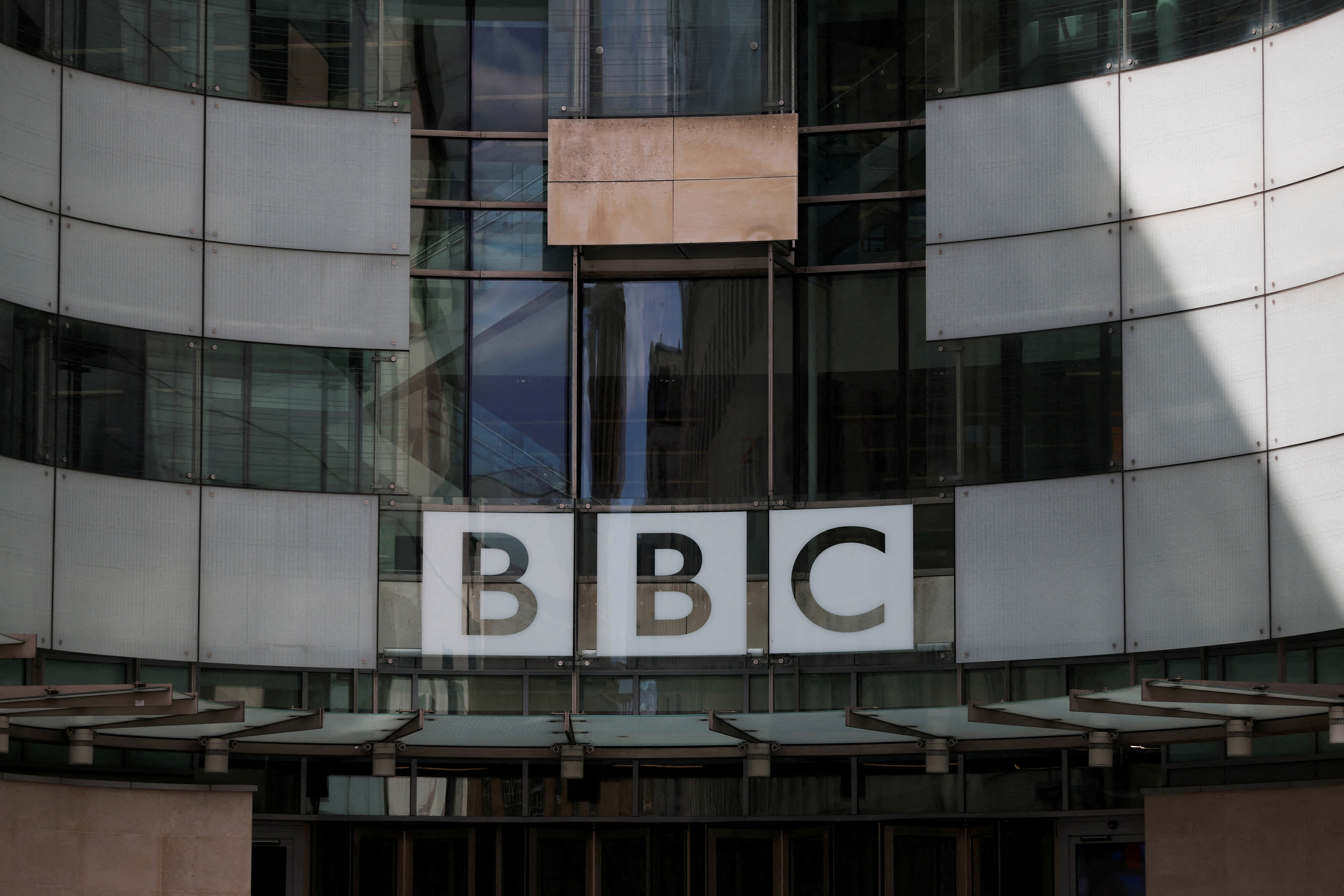 FILE PHOTO: The BBC logo is displayed above the entrance to the BBC headquarters in London