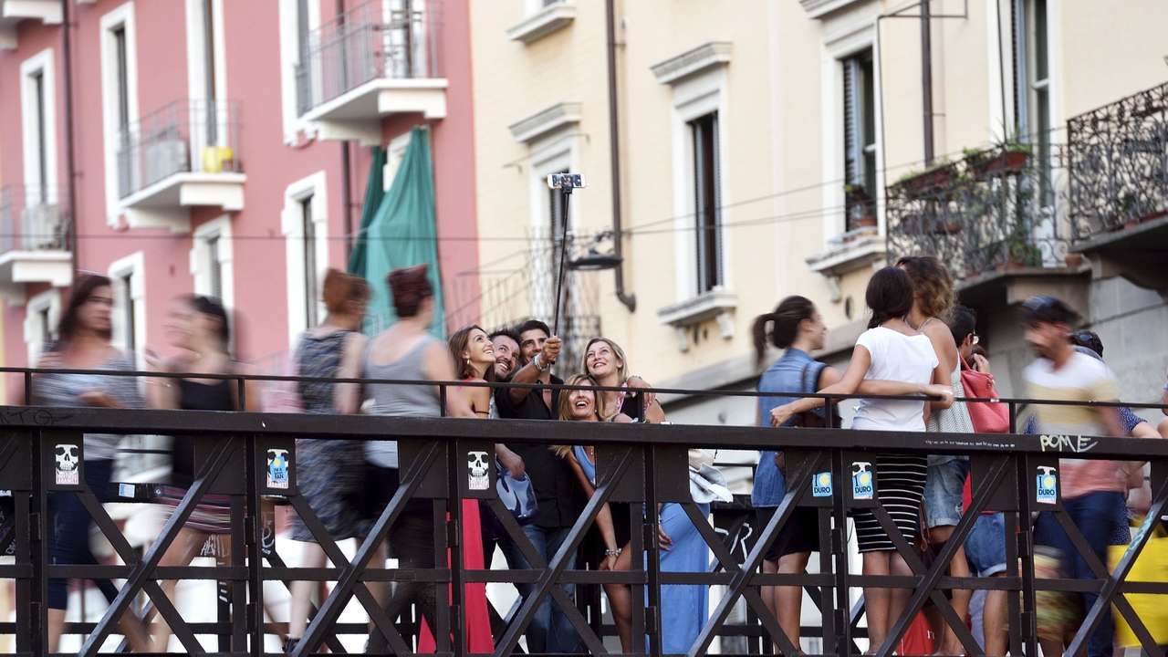 FILE PHOTO: People take a selfie at Naviglio Gran Canal in Milan