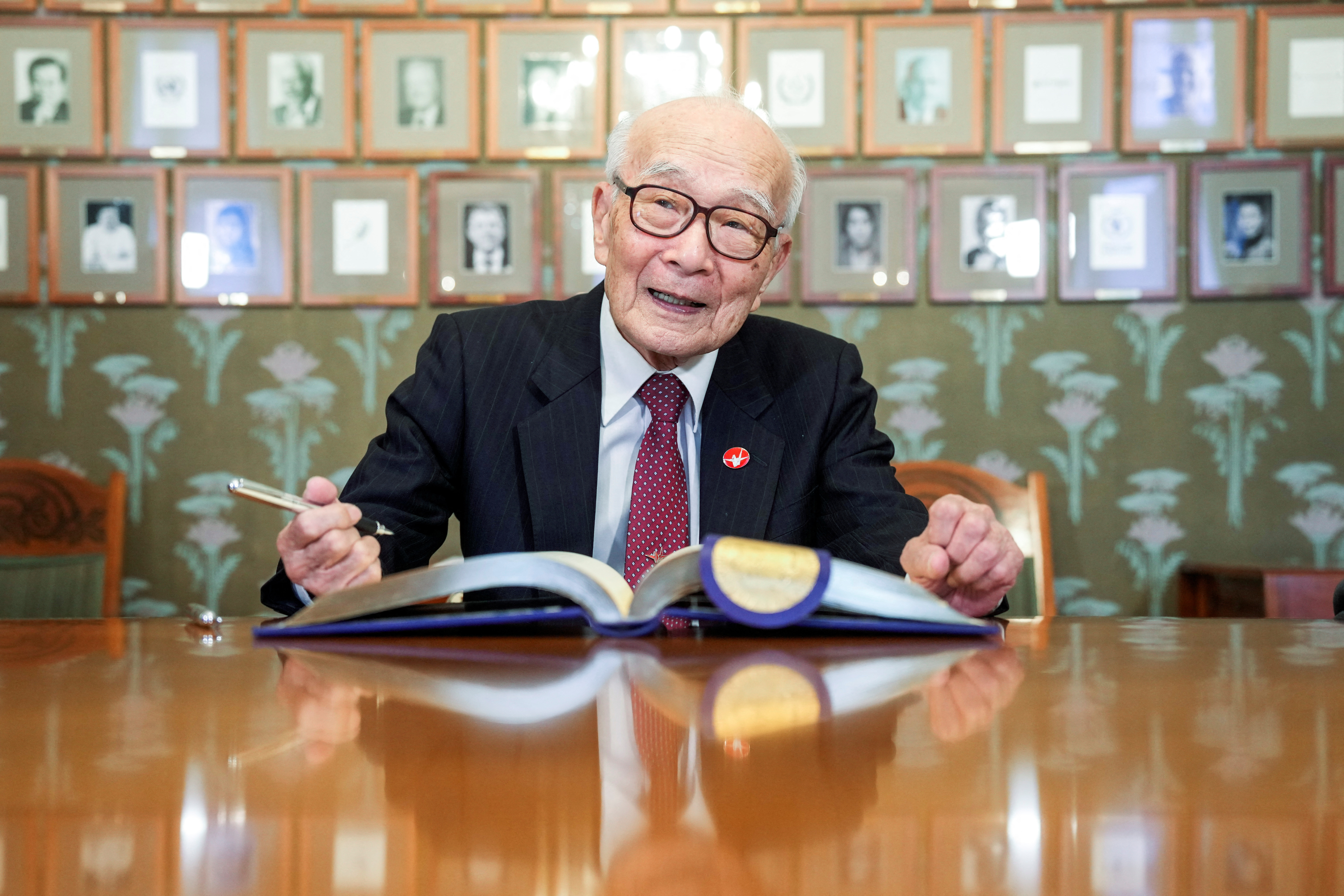 Terumi Tanaka, Shigemitsu Tanaka and Toshiyuki Mimaki, the representatives of 2024 Nobel Peace Prize winner Nihon Hidankyo sign the guest book at the Nobel Institute in Oslo