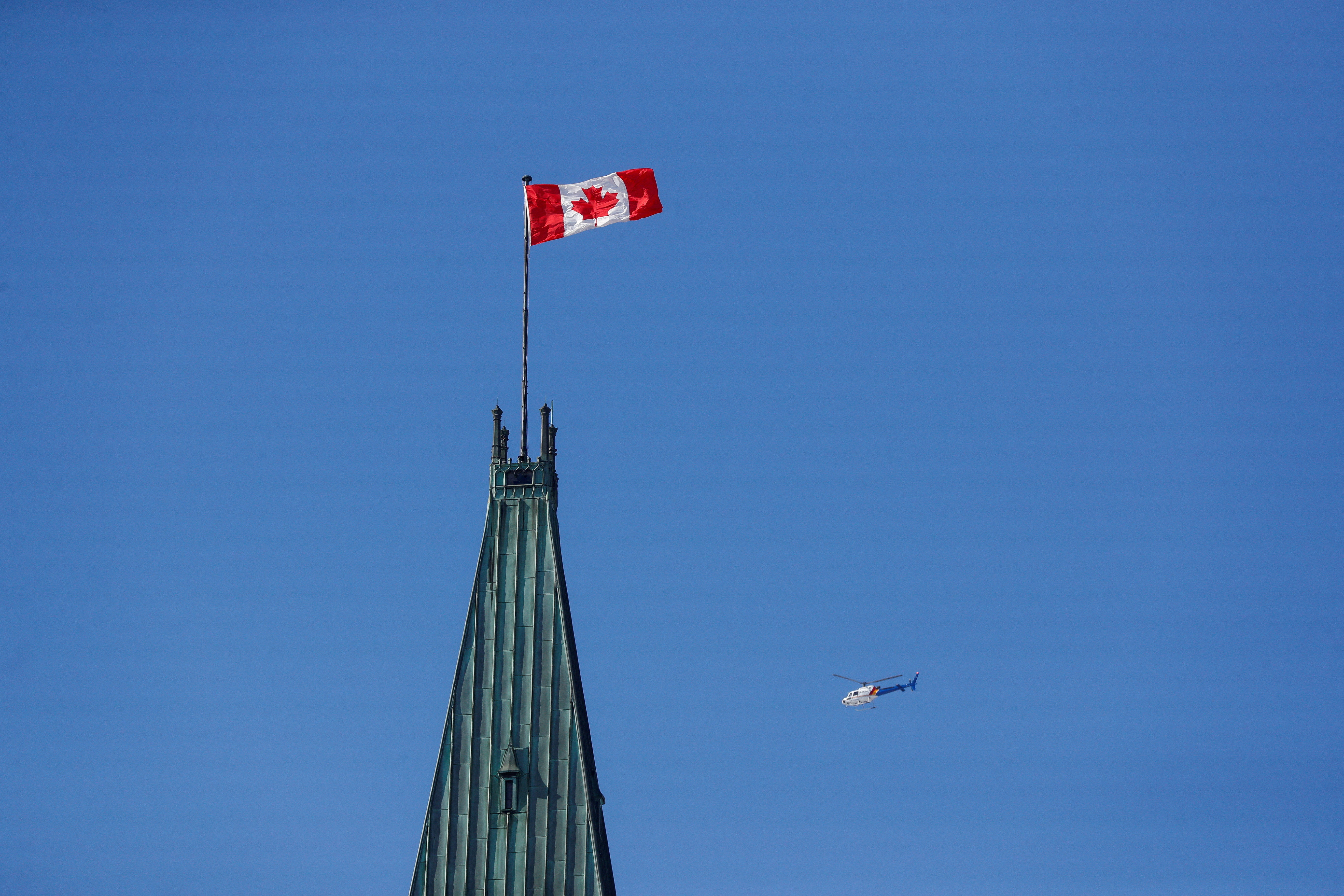 FILE PHOTO: RCMP helicopter flies past the Peace Tower on Parliament Hill in Ottawa