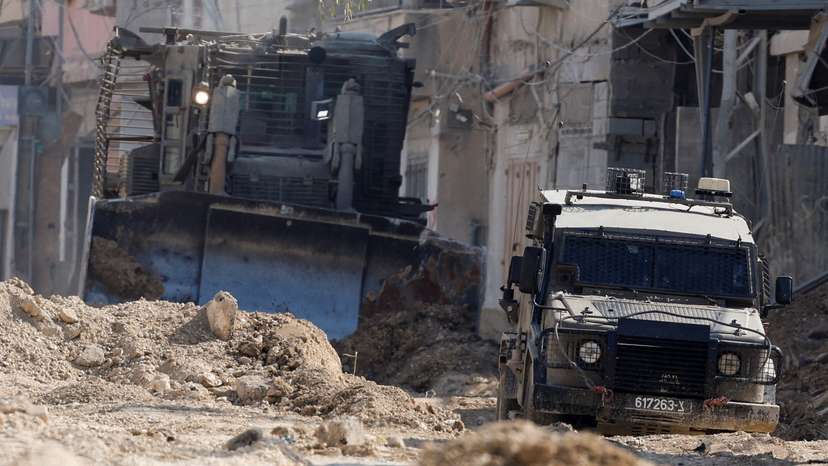 Israeli military vehicles operate during an Israeli raid in Tulkarm