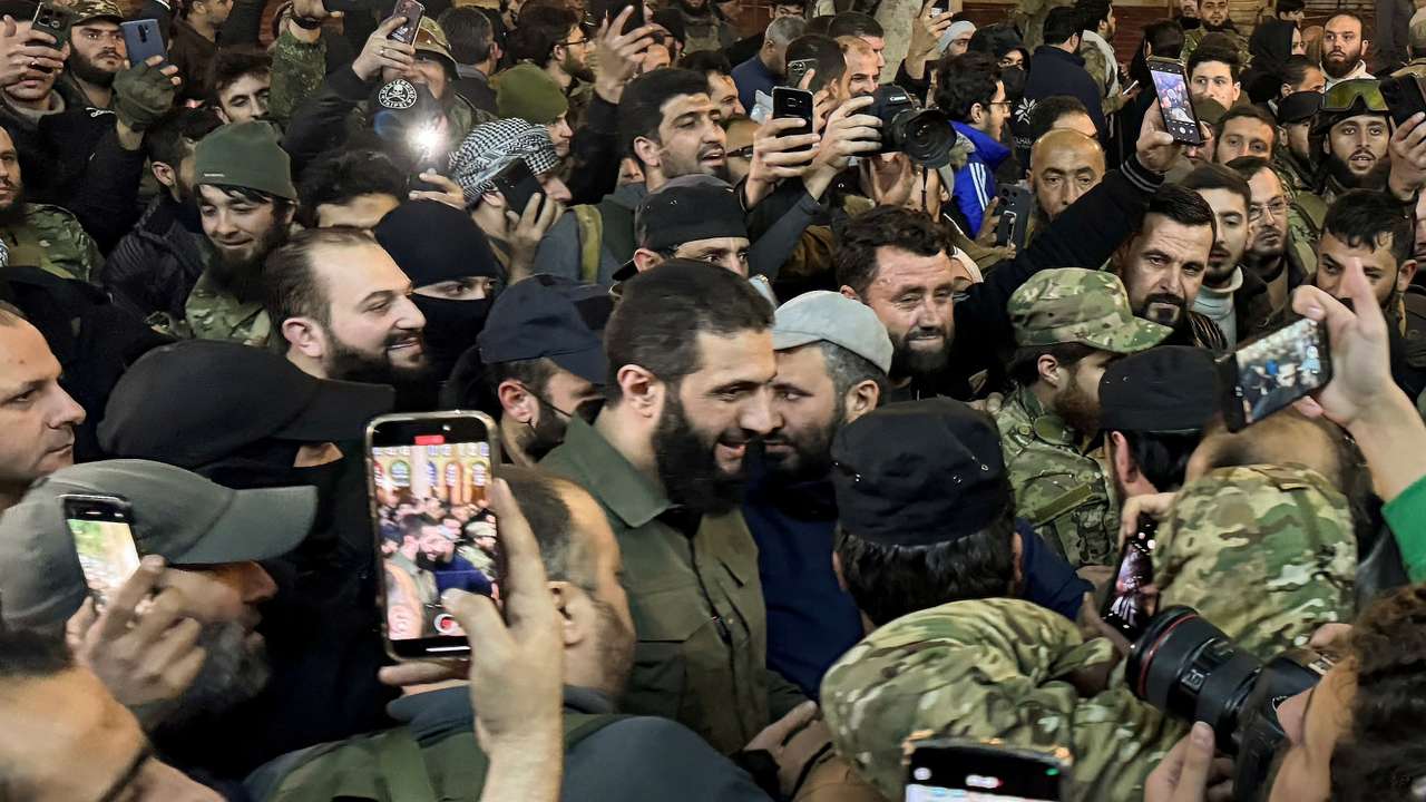 Top rebel commander Abu Mohammed al-Golani greets the crowd at Ummayad Mosque in Damascus