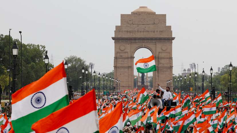 People wave Indian flags in support of the Indian Armed Forces, following the ceasefire announcement between India and Pakistan, in Delhi