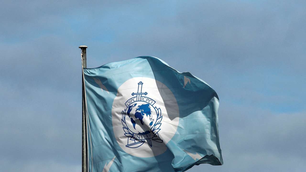 A flag with the logo of the International Criminal Police Organization (INTERPOL) is seen at the headquarters in Lyon
