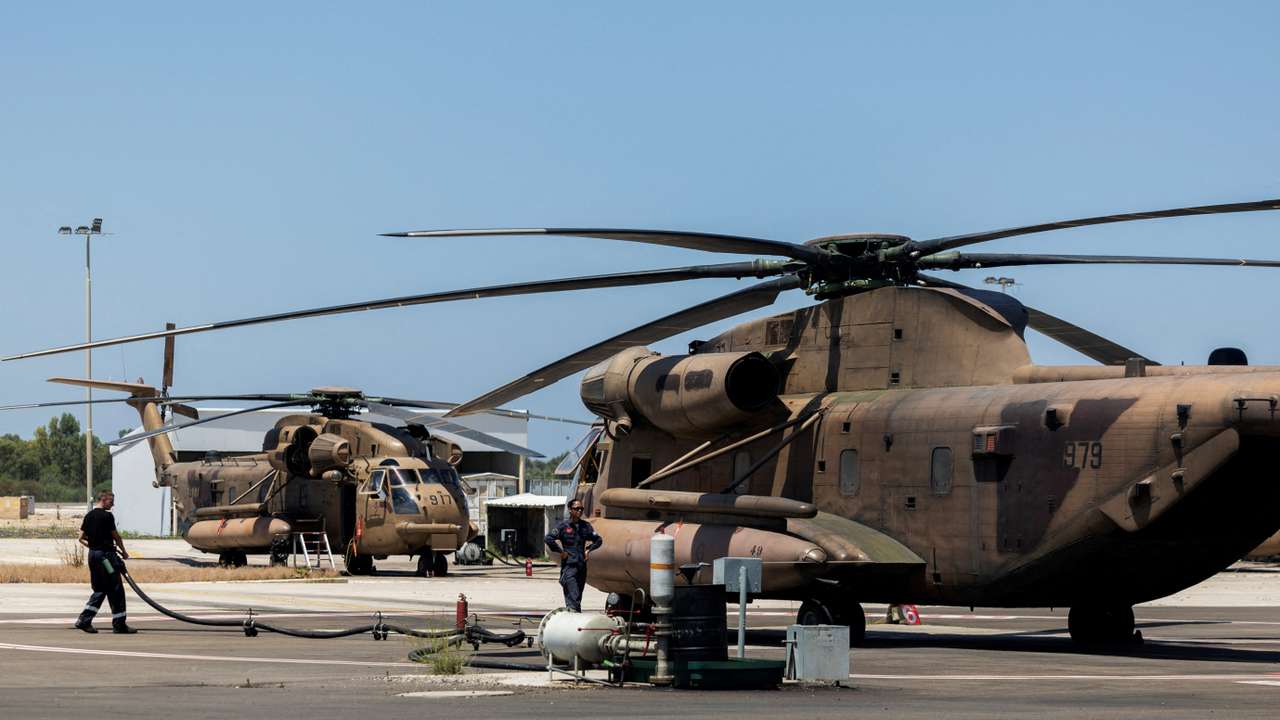 Ground crew works next to military helicopter in Tel Nof military base in central Israel