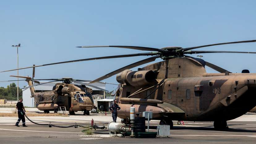 Ground crew works next to military helicopter in Tel Nof military base in central Israel