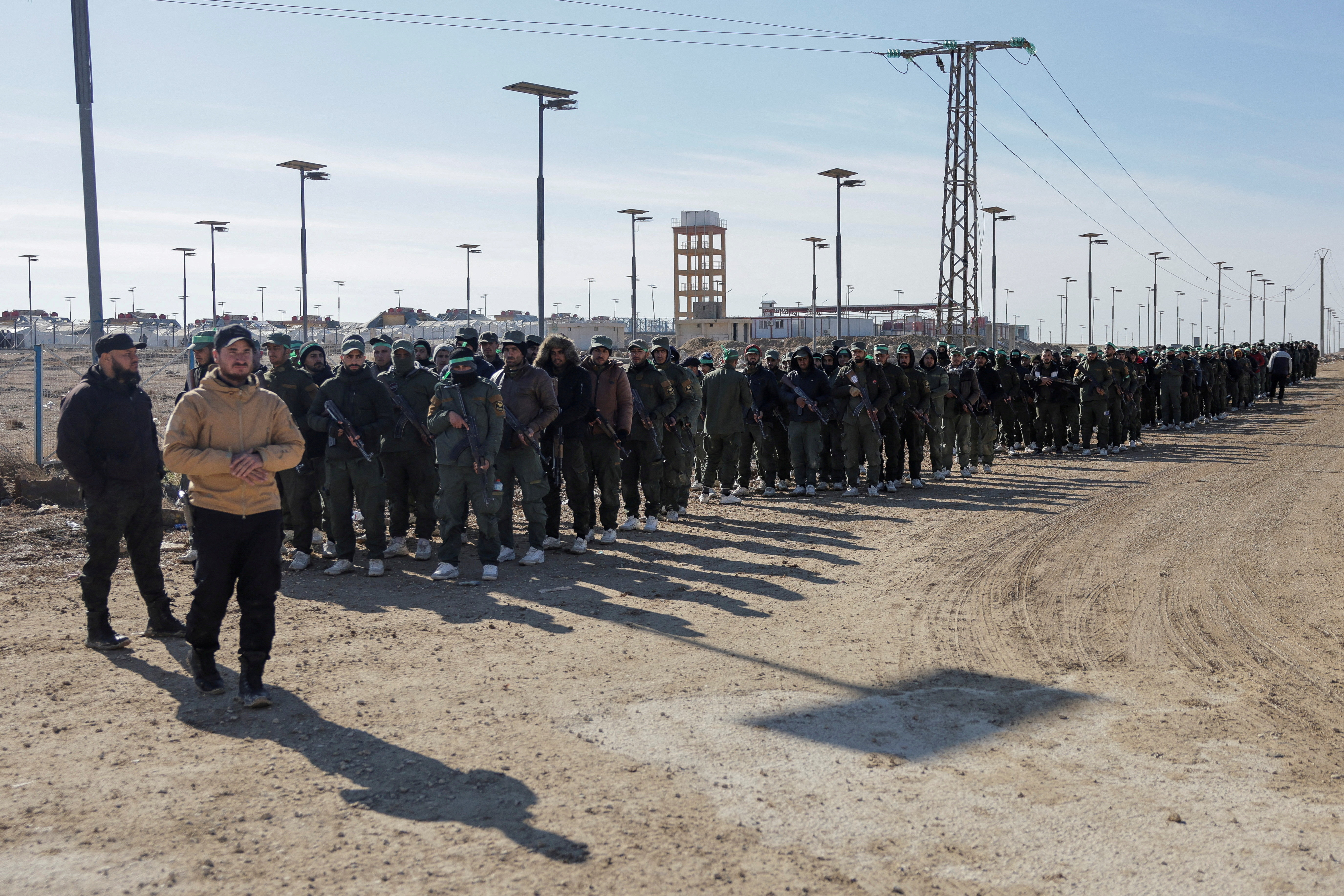 FILE PHOTO: Detainees gather at al-Hol camp after the Syrian government took control of it, in Hasaka