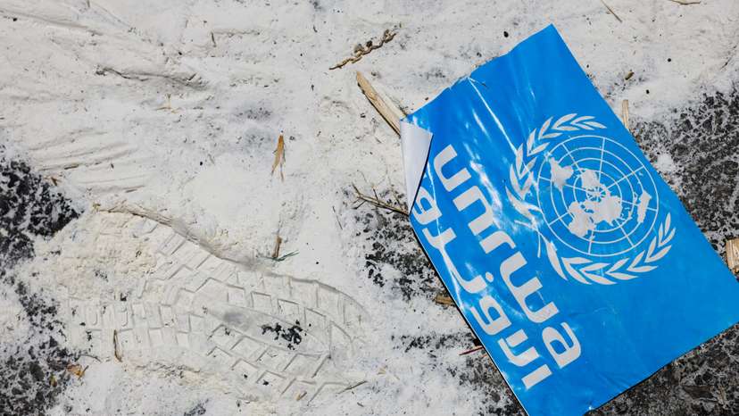 FILE PHOTO: A United Nations Relief and Works Agency (UNRWA) sign lies on the ground, amid the ongoing conflict in Gaza between Israel and the Palestinian Islamist group Hamas, at the Kerem Shalom crossing in southern Israel
