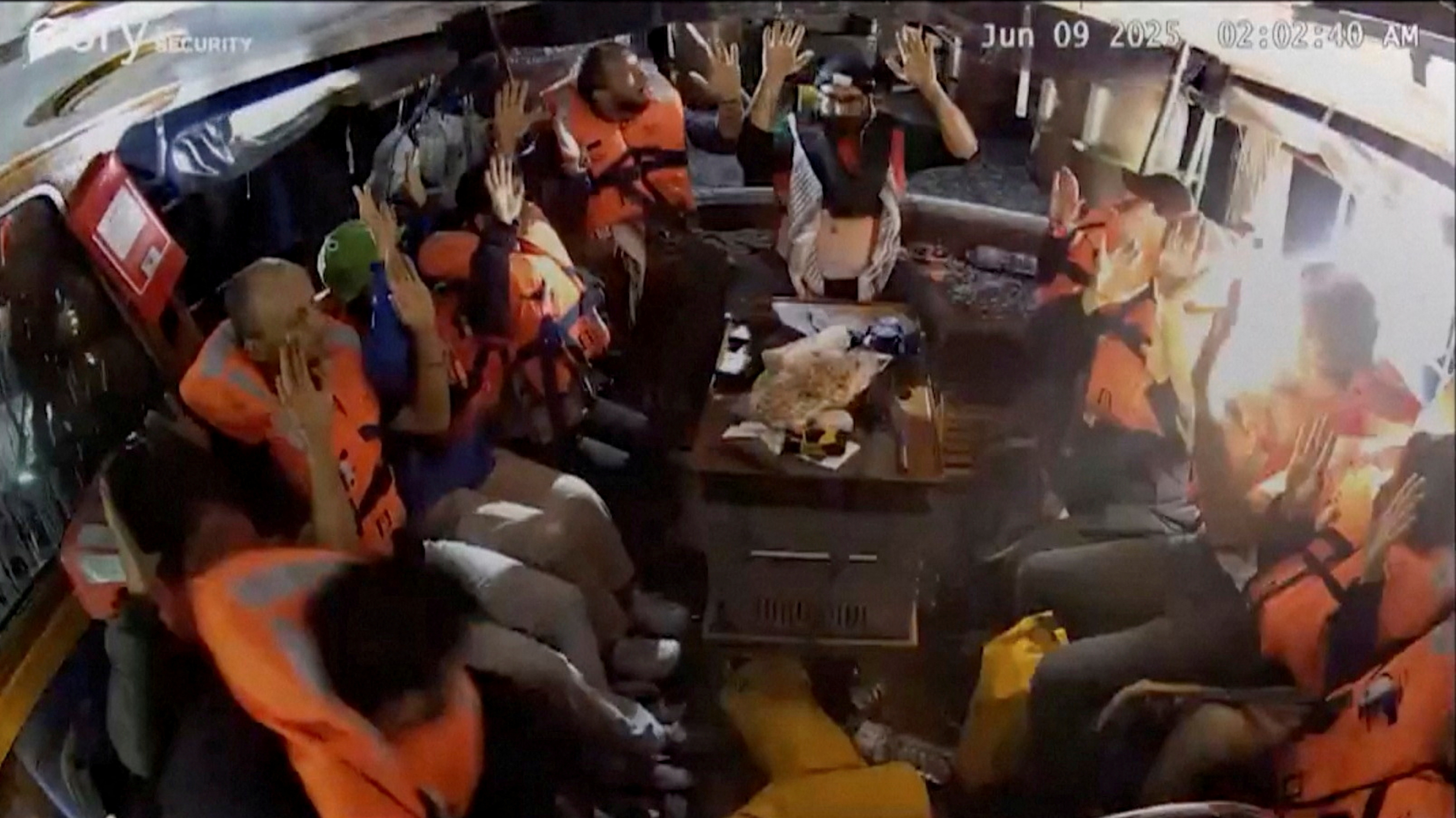 A surveillance footage shows crew of the Gaza-bound British-flagged yacht "Madleen" put their hands up as strong light came into the vessel