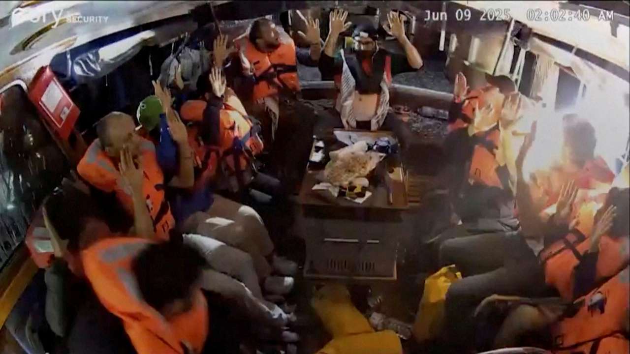 A surveillance footage shows crew of the Gaza-bound British-flagged yacht "Madleen" put their hands up as strong light came into the vessel