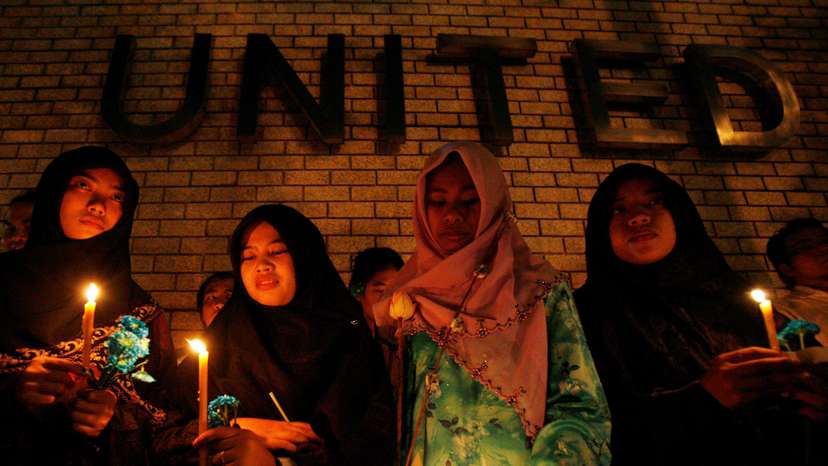 FILE PHOTO: Thai-Muslim student hold a candle light vigil for victims of the Tak Bai shooting on it's third anniversary outside the United Nation building in Bangkok