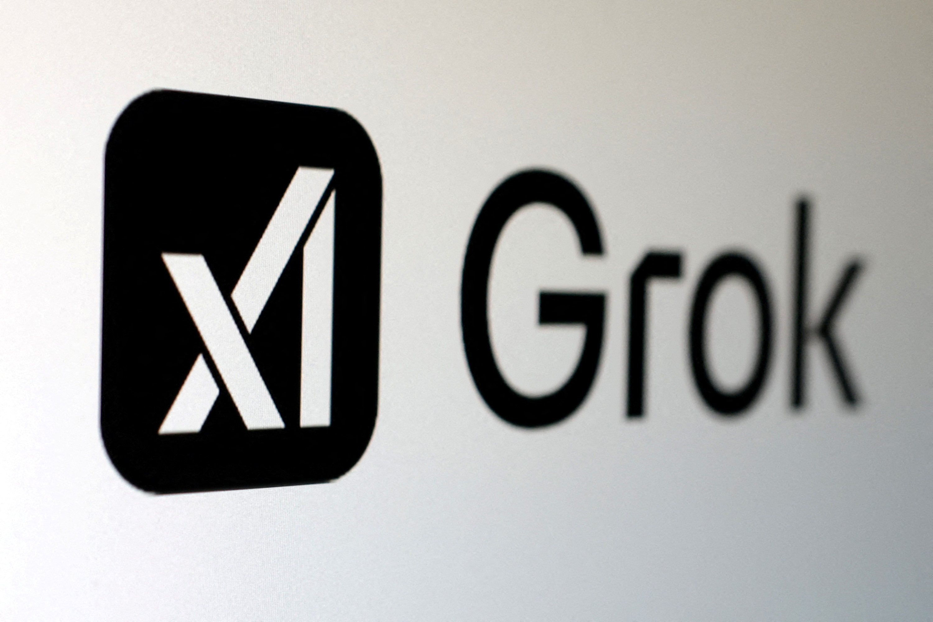 FILE PHOTO: Illustration shows xAI and Grok logos