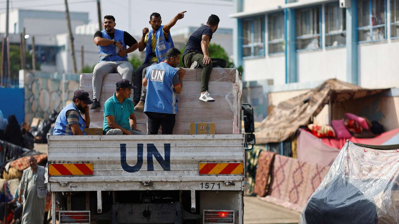 Palestinians receive aid distributed by the United Nations, in Khan Younis