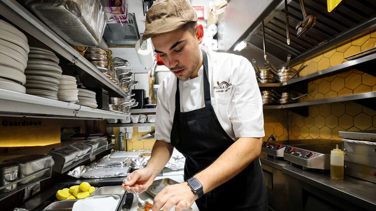 Chef Davide Sanna works in the kitchen of Piccola Cucina in the SoHo area of New York