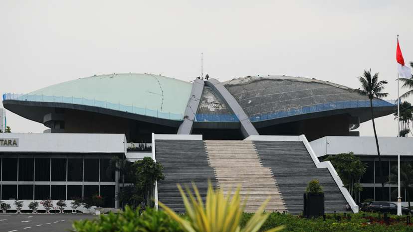 A worker walks on the roof of Indonesian Parliament Building in Jakarta