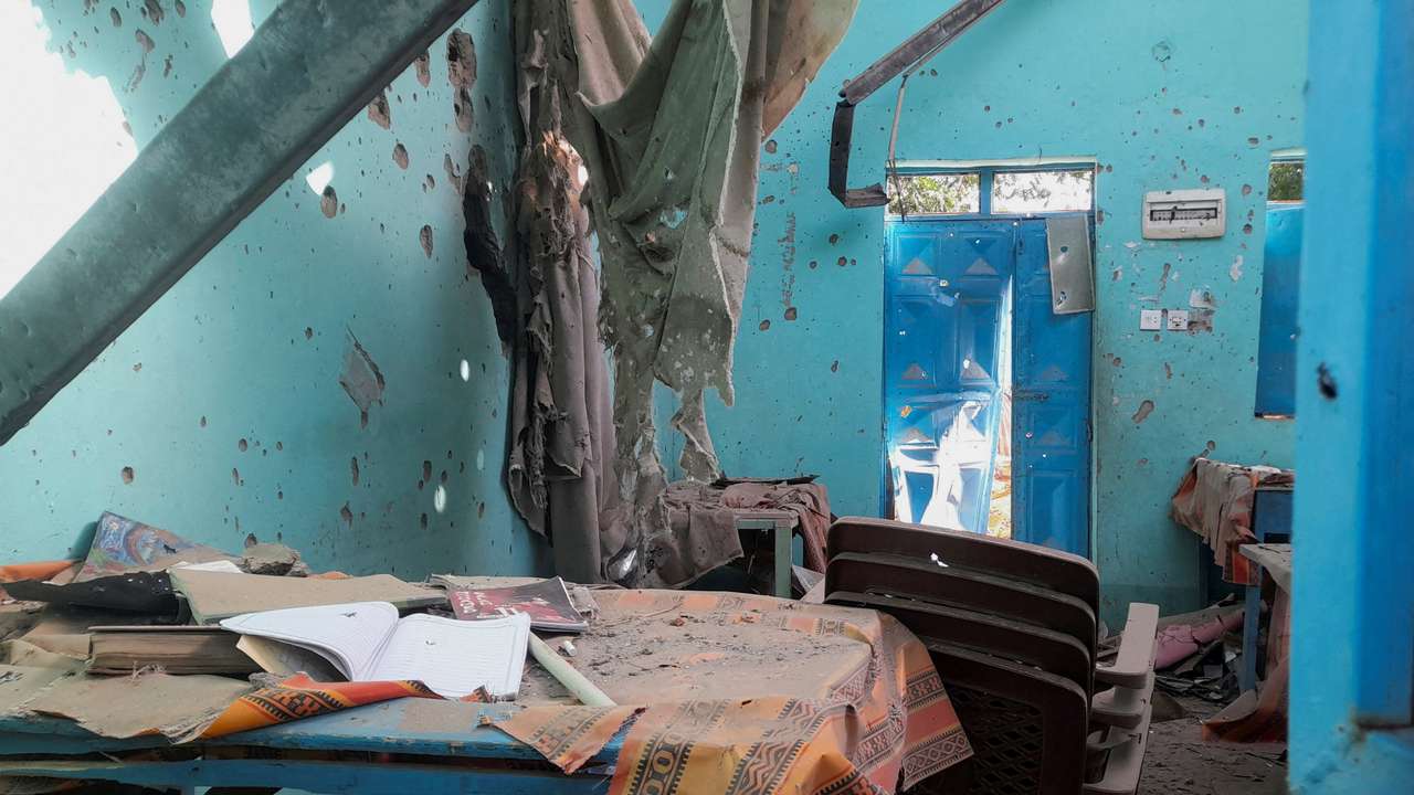 A desk bearing signs of shelling in a school where displaced people are sheltering, in El Fasher