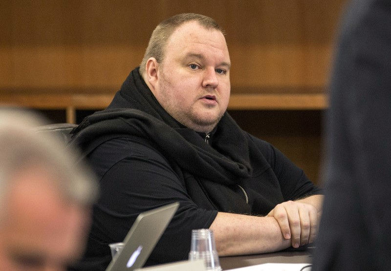 FILE PHOTO: German tech entrepreneur Kim Dotcom sits in a chair during a court hearing in Auckland, New Zealand