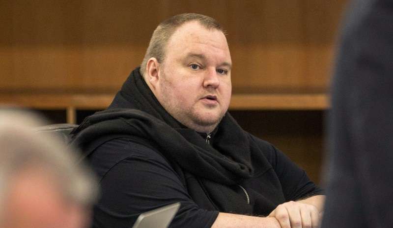 FILE PHOTO: German tech entrepreneur Kim Dotcom sits in a chair during a court hearing in Auckland, New Zealand