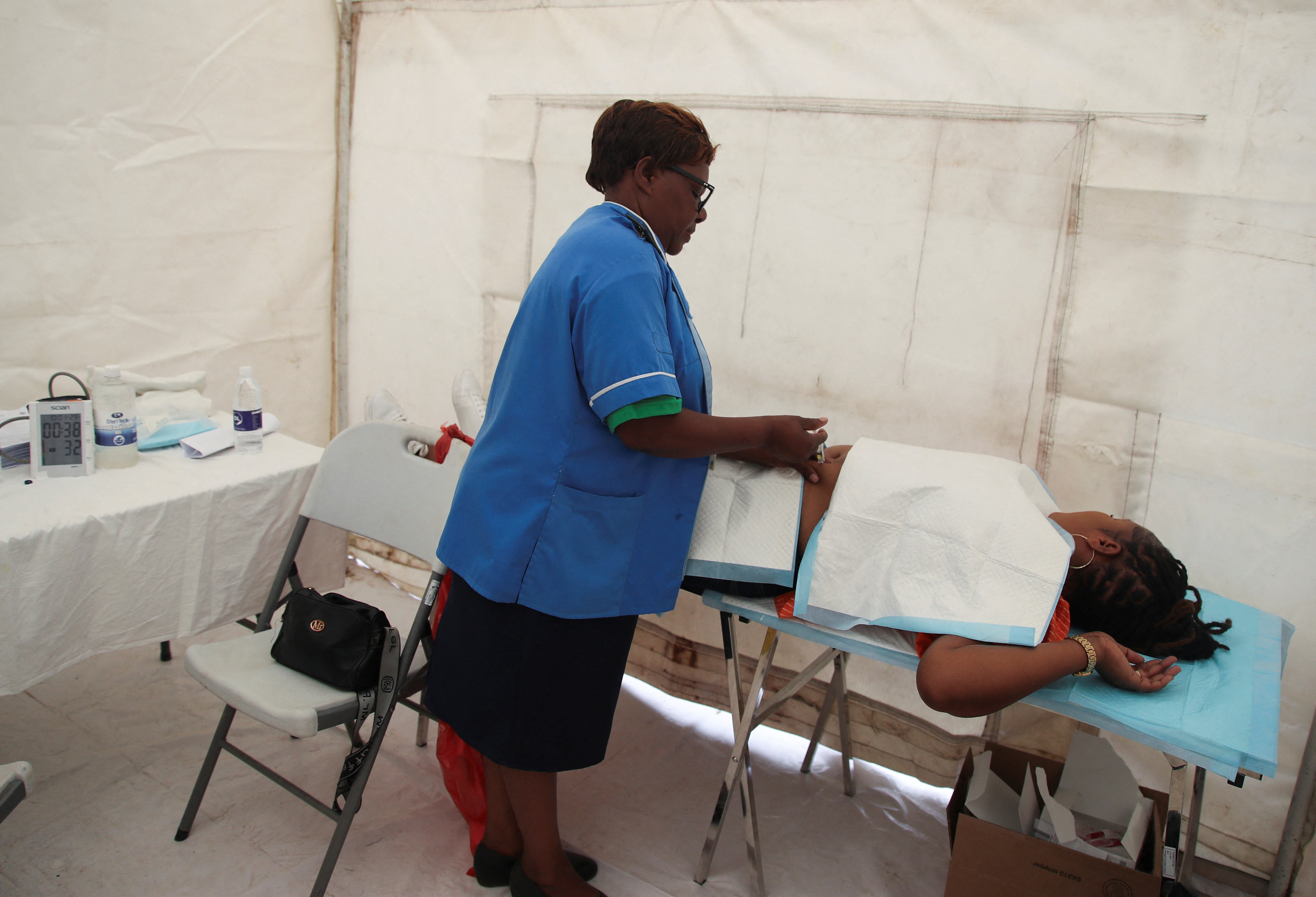 A health official gives a patient Lenacapavir, a long‑acting HIV prevention injection, in Epworth, outside the capital Harare