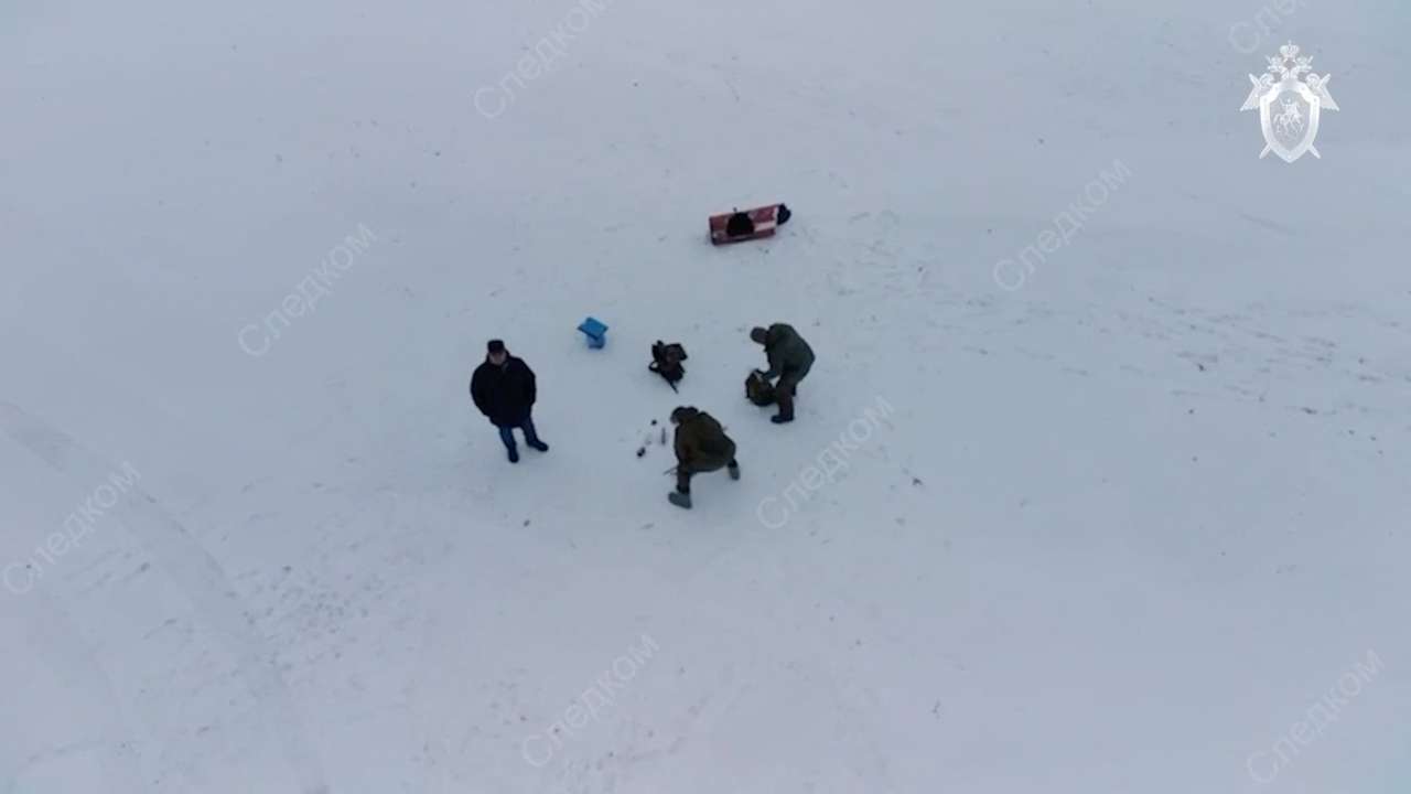 FILE PHOTO: Investigators examine fragments of missiles at the crash site of Russian Il-76 military plane in Belgorod region