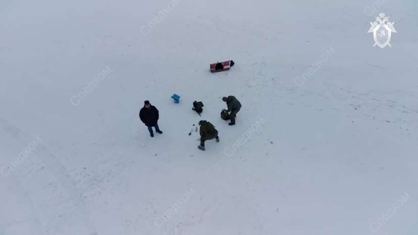 FILE PHOTO: Investigators examine fragments of missiles at the crash site of Russian Il-76 military plane in Belgorod region