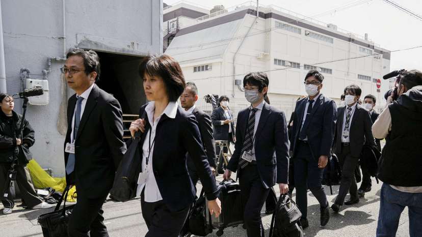 Japanese health ministry officials head to search a Kobayashi Pharmaceutical Co. factory in Osaka
